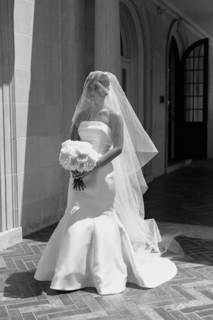 Artistic black and white photos of a bride in flowing white dress on a columned porch.
