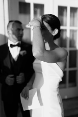 Artistic black and white wedding photo capturing intimate moments between the couple.