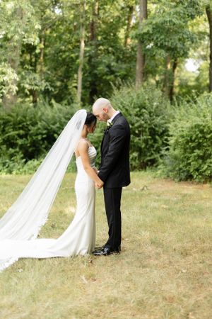 A romantic wedding sequence showing a couple in an outdoor garden setting with flowing white dress and dark suit.