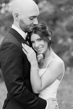 Intimate black and white wedding portraits showing tender moments between newlyweds.
