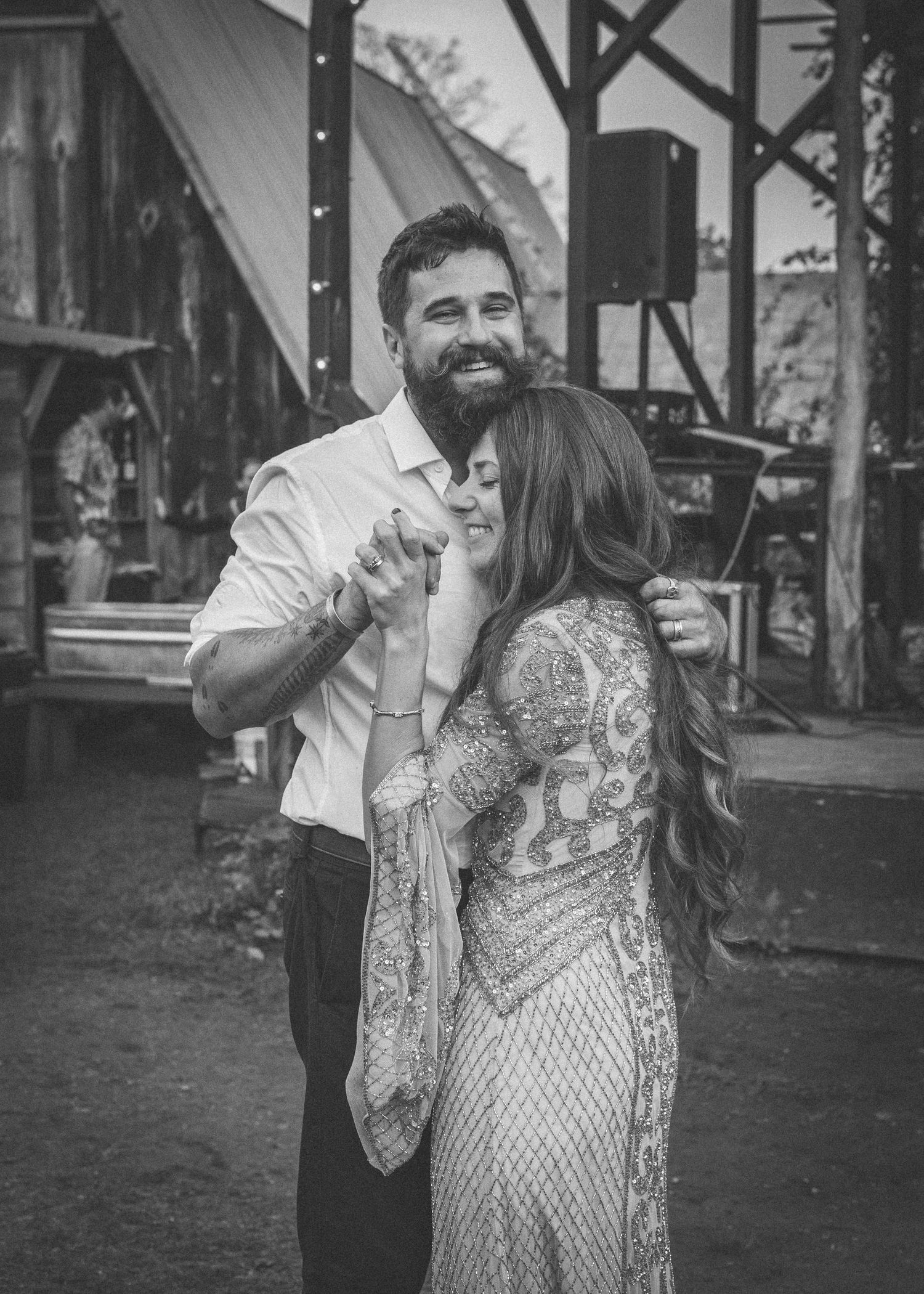 A couple shares a romantic dance together in black and white vintage style photography.