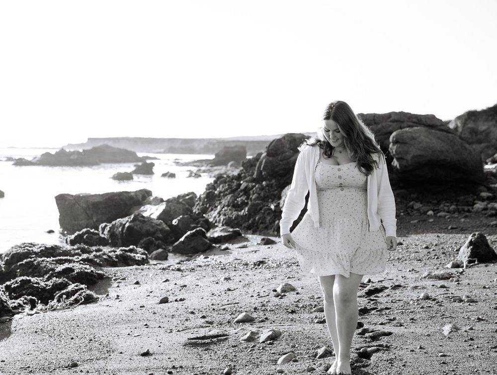 A series of vintage black and white film stills show people walking on a rocky beach landscape.