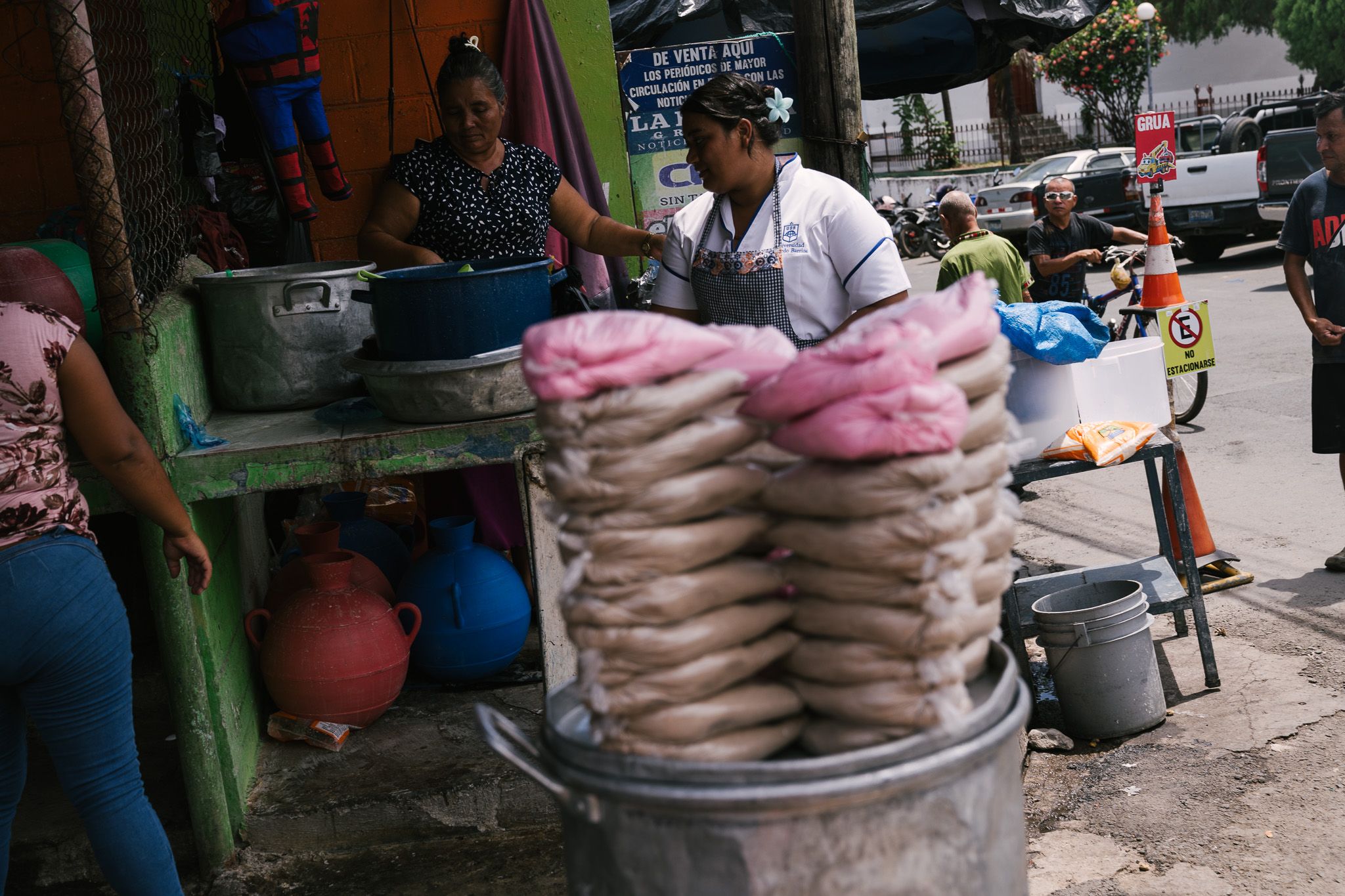 Stack of fresh tortillas being sold at a street market stall.