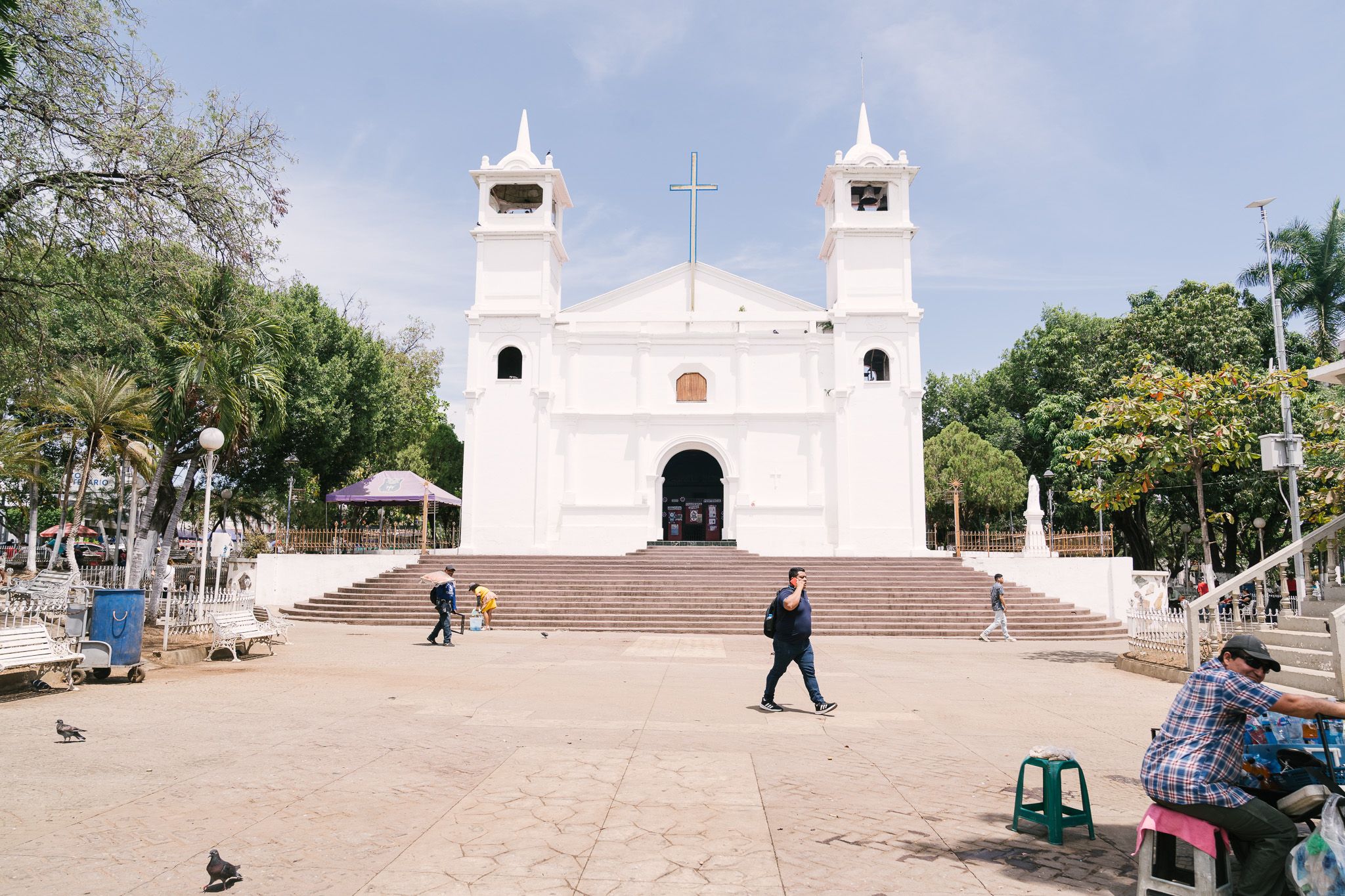 White colonial church with twin bell towers and steps leading to entrance.