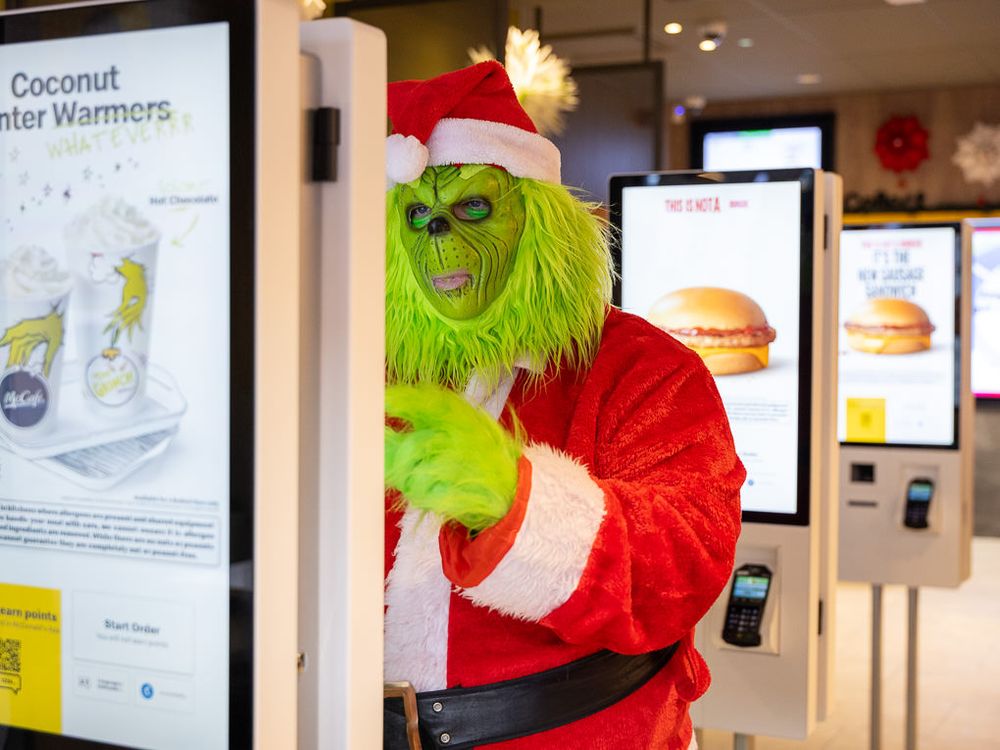 The Grinch ordering from a McDonald's digital screen at the opening of the Rickmansworth restaurant.