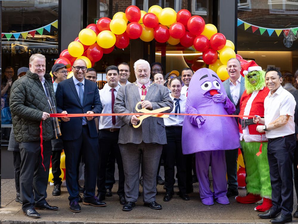 McDonald’s franchisee helping prepare burgers in the kitchen at the Rickmansworth restaurant opening, photographed for PR and press use.