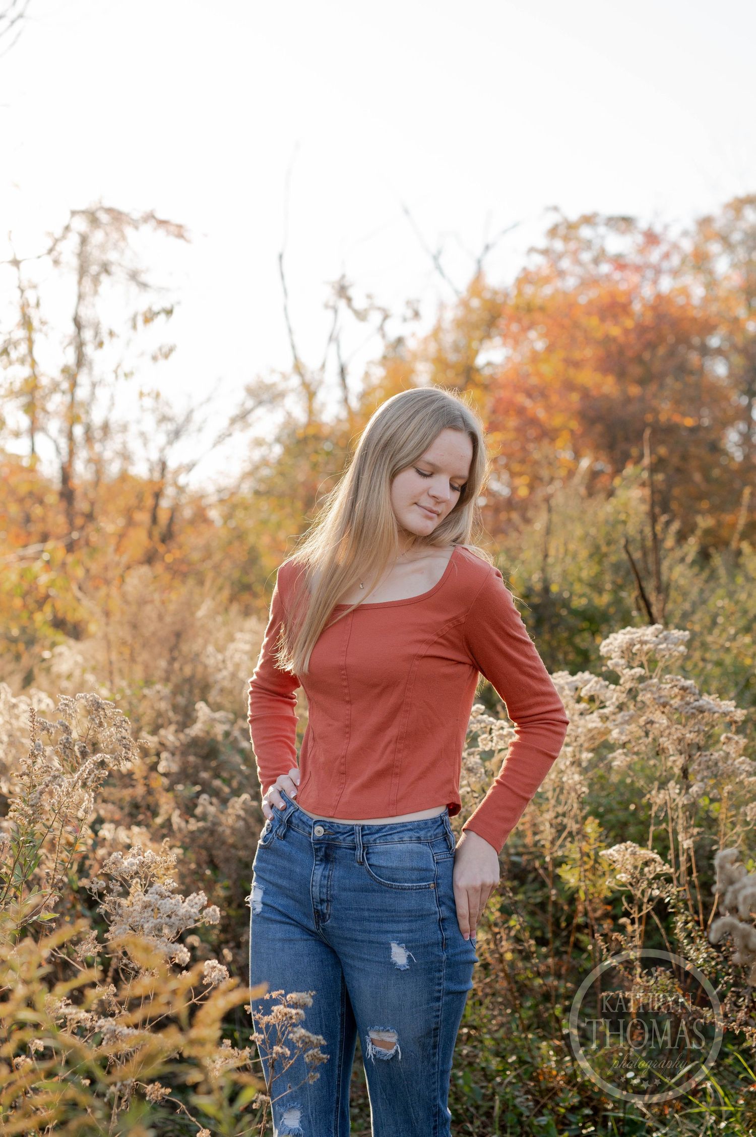 Casual portrait amongst dried wildflowers with soft autumn lighting and fall colors.