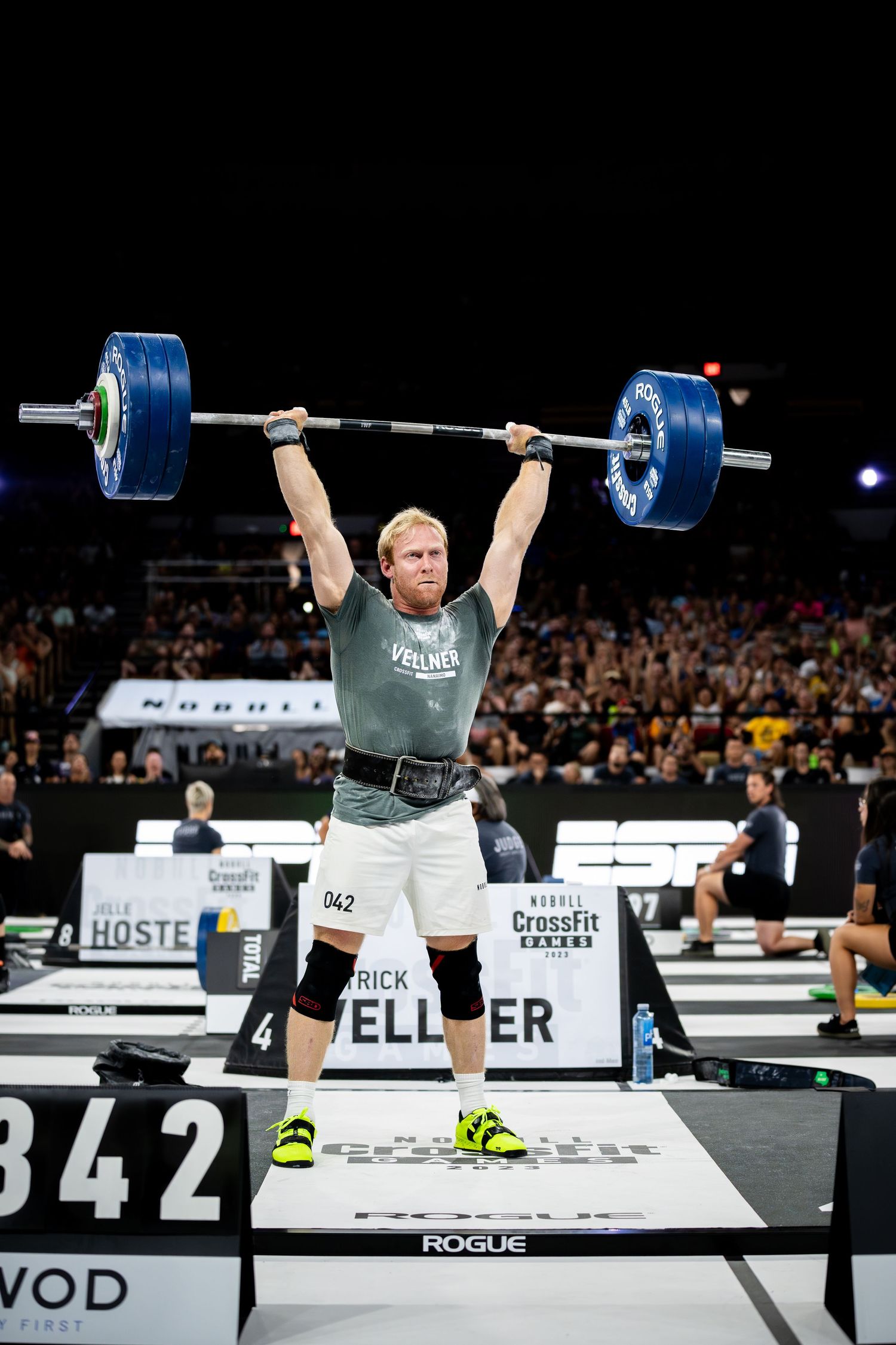 Pat Velner performing overhead barbell lift during CrossFit competition.