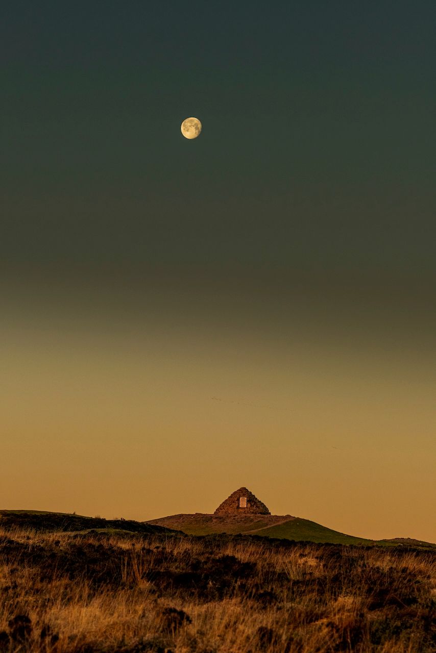 Landscape art photo of dawn / sunrise over Exmoor National Park, with Dunkery beacon and the moon both visible in the morning light
