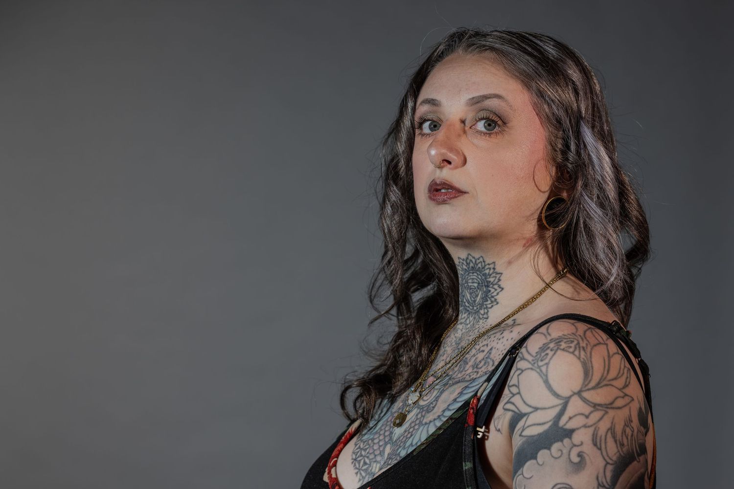 Side profile portrait of Laurel she is standing in a three-quarter pose on the right side of the photo facing towards the left