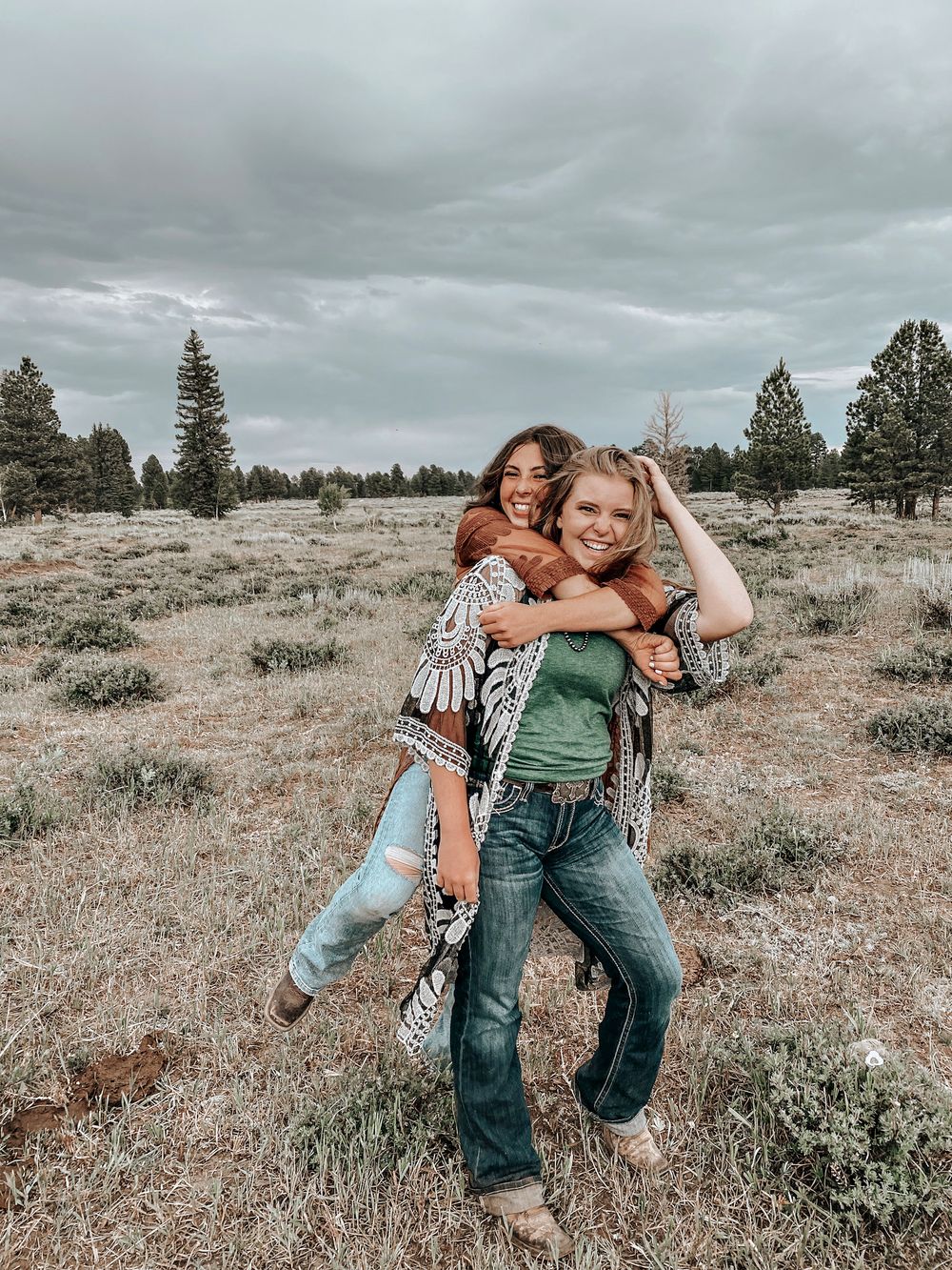 Friends playing and laughing together in a rustic outdoor setting.