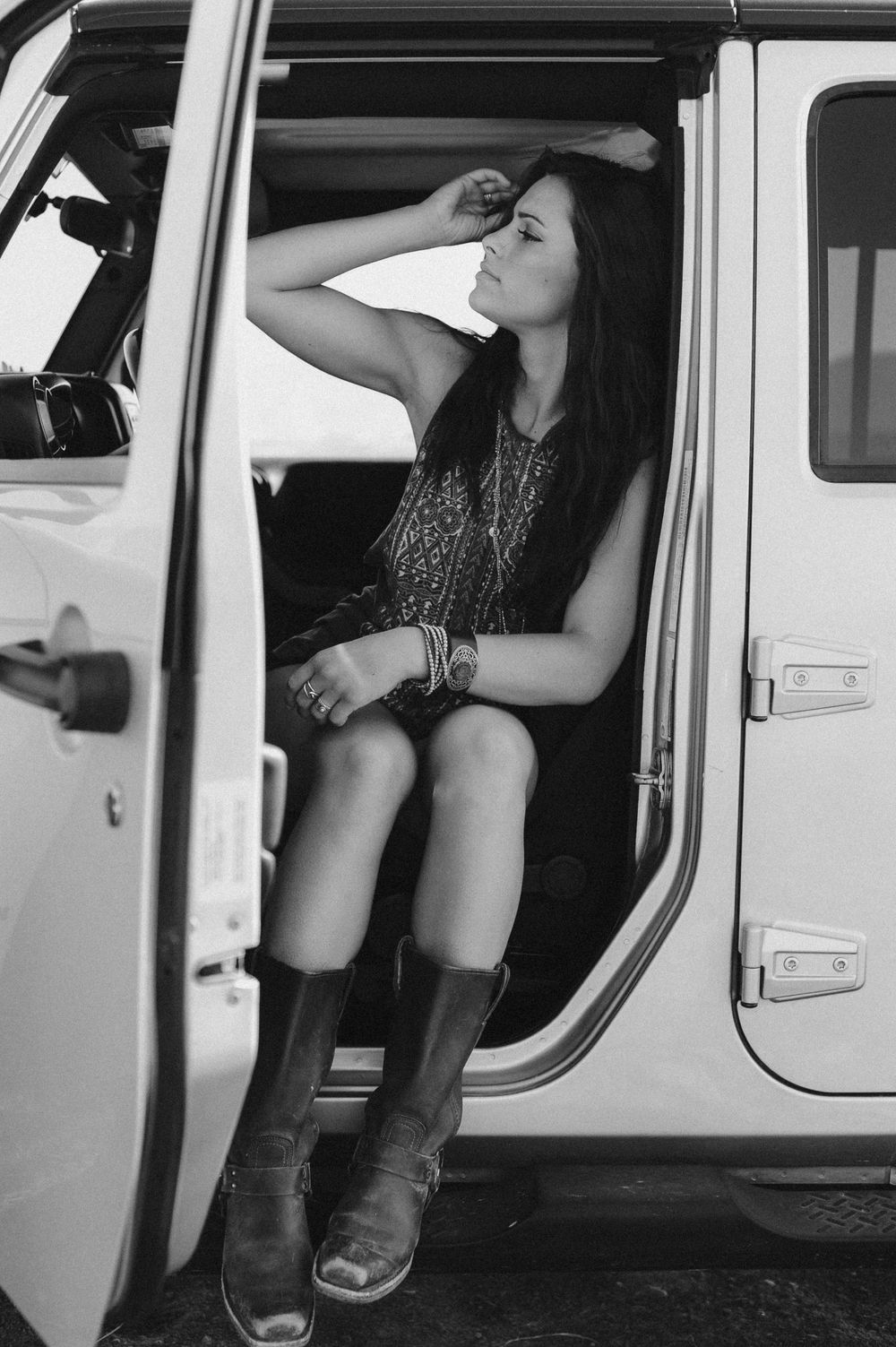 Artistic black and white portraits taken inside a vintage white vehicle.