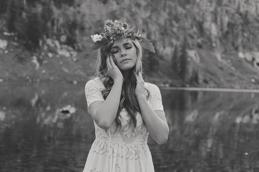 Dramatic mountainside portraits near a reflective lake surface.