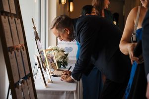 Wedding preparations take place in an elegant indoor venue with natural lighting streaming through windows.