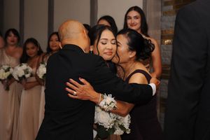 Couples dance together at a wedding reception, enjoying romantic moments on the dance floor.