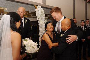 Wedding guests fully engaged in dancing and celebration at an elegant indoor wedding reception venue.