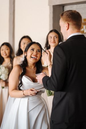 A joyful wedding party moment as they read heartfelt letters and notes together.