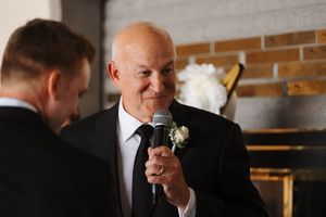 Formal reception area with brick wall accent and wedding decor in an indoor venue.