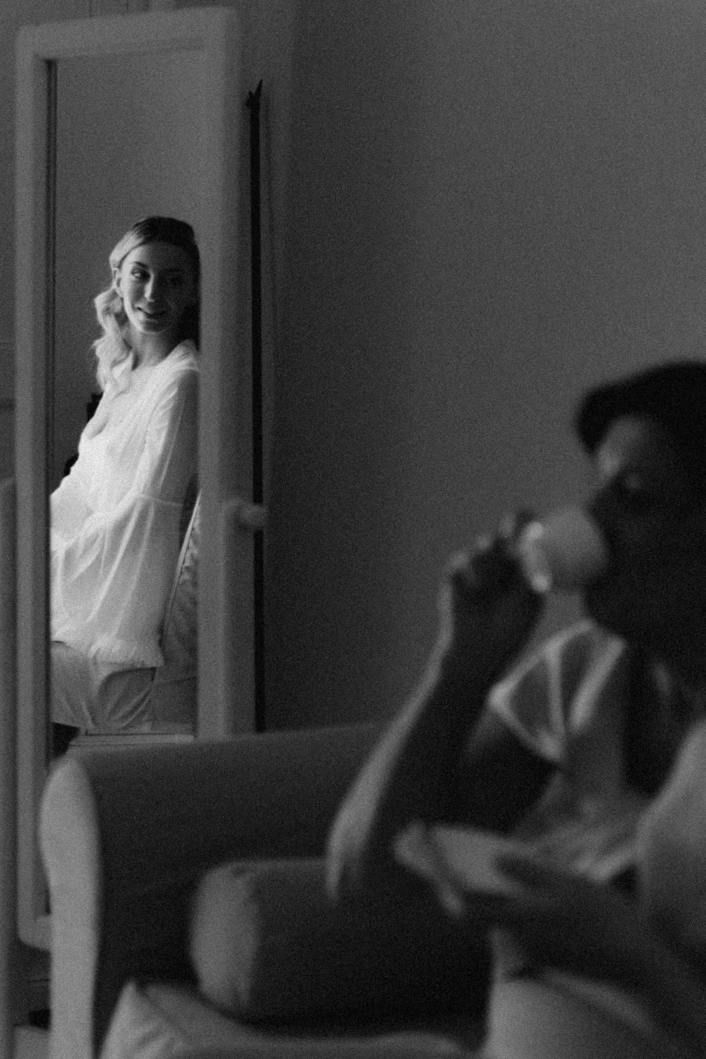 Black and white surveillance footage shows a sequence of silhouettes of students in a classroom through window panels.