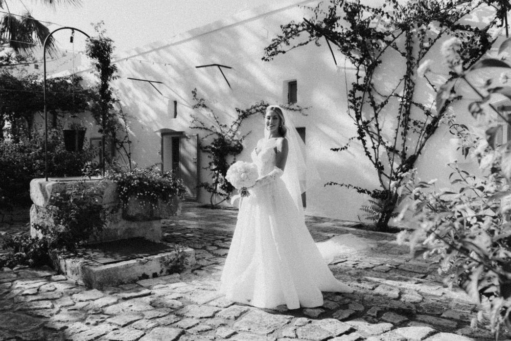 A collection of black and white wedding photographs arranged in a horizontal strip showing romantic outdoor moments.