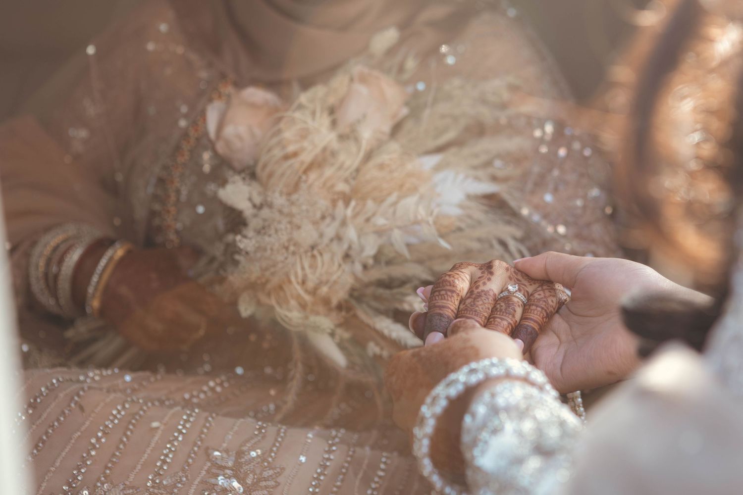 Close-up of a traditional Indian mehndi design on hands with intricate patterns and details.