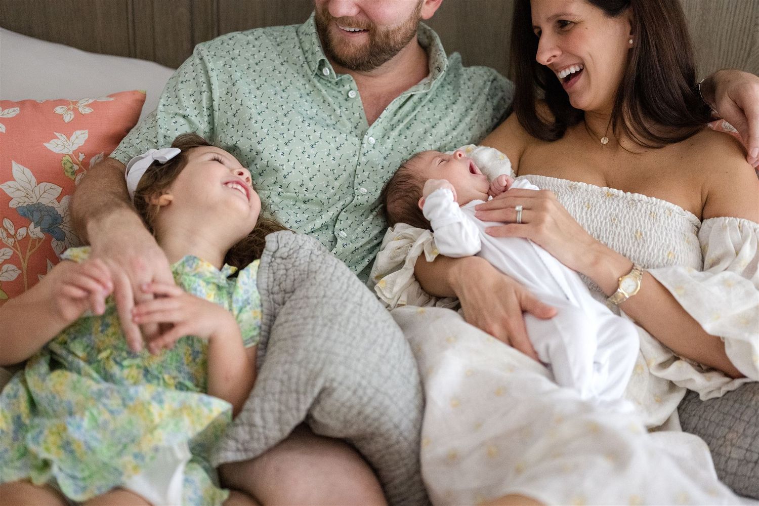 A collection of candid shots shows a newborn baby with parents in soft sage green, white, and neutral tones.