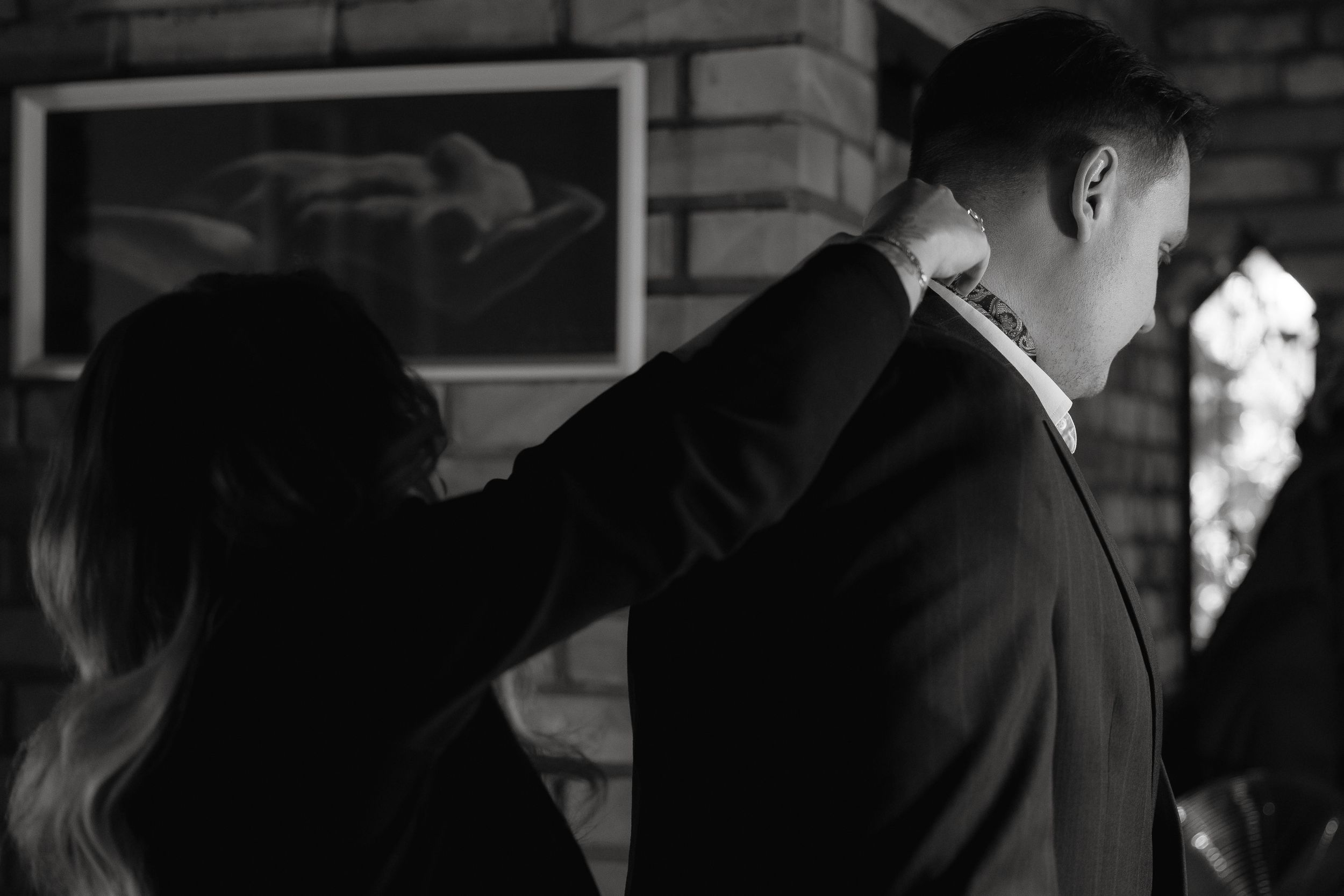 Black and white photograph of a 1960s formal dance with people swaying to romantic music in an elegant ballroom.