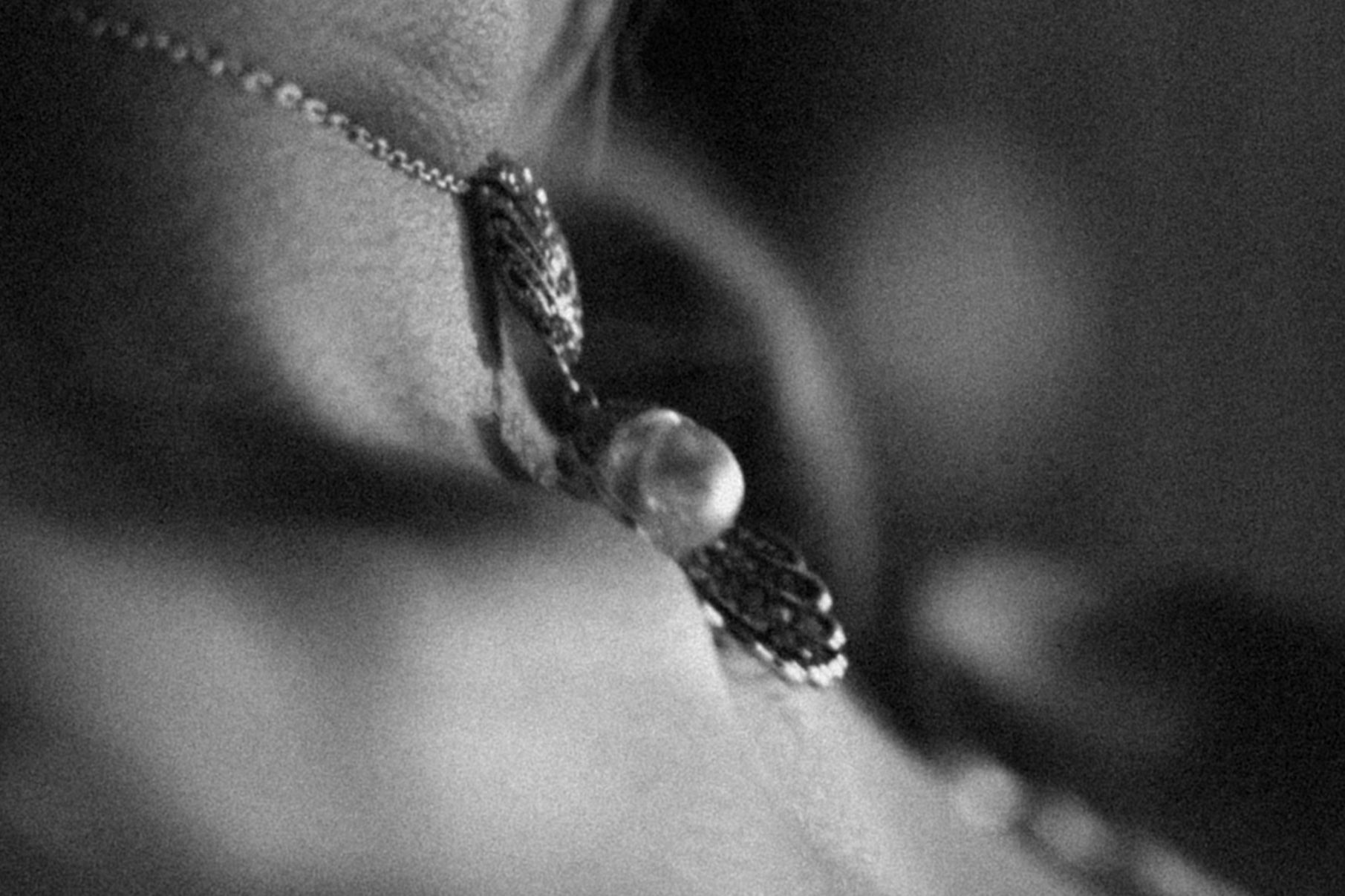 Black and white close up image of an eye with long eyelashes in soft focus.