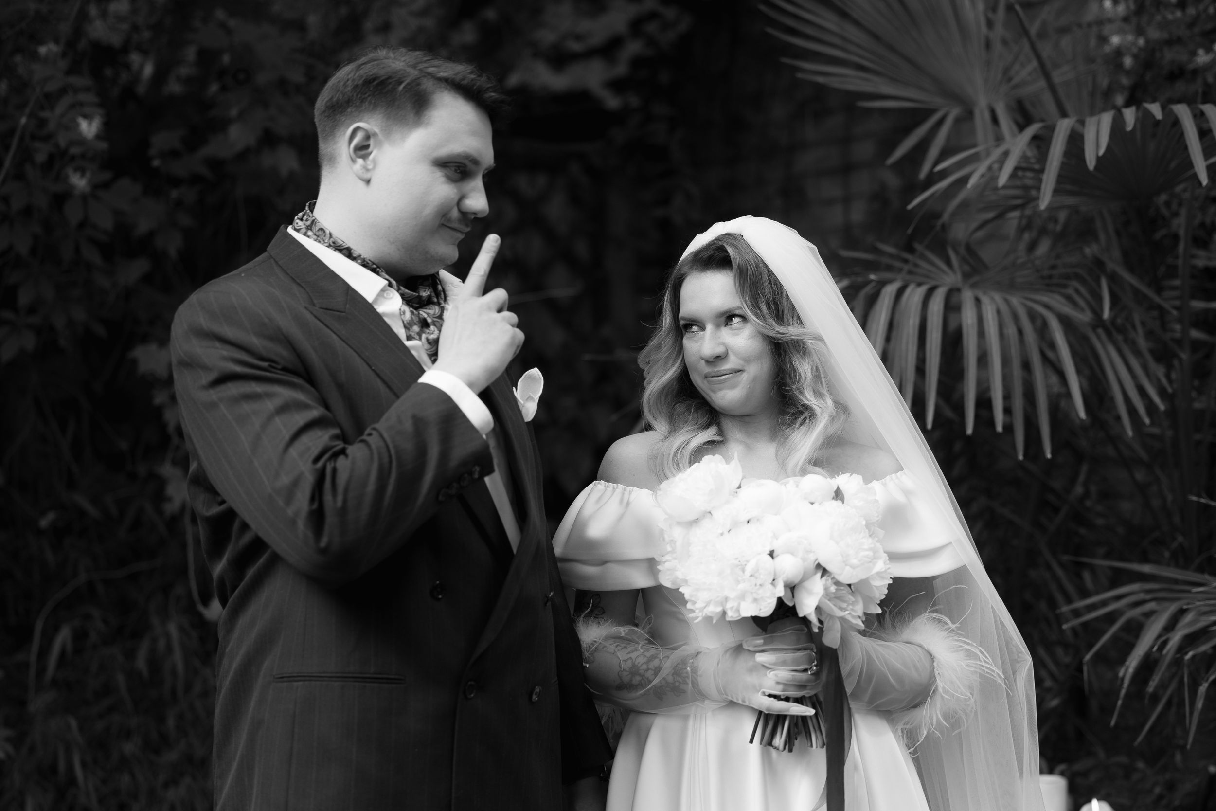 Black and white wedding photographs showing romantic moments between a couple in formal attire during their celebration.