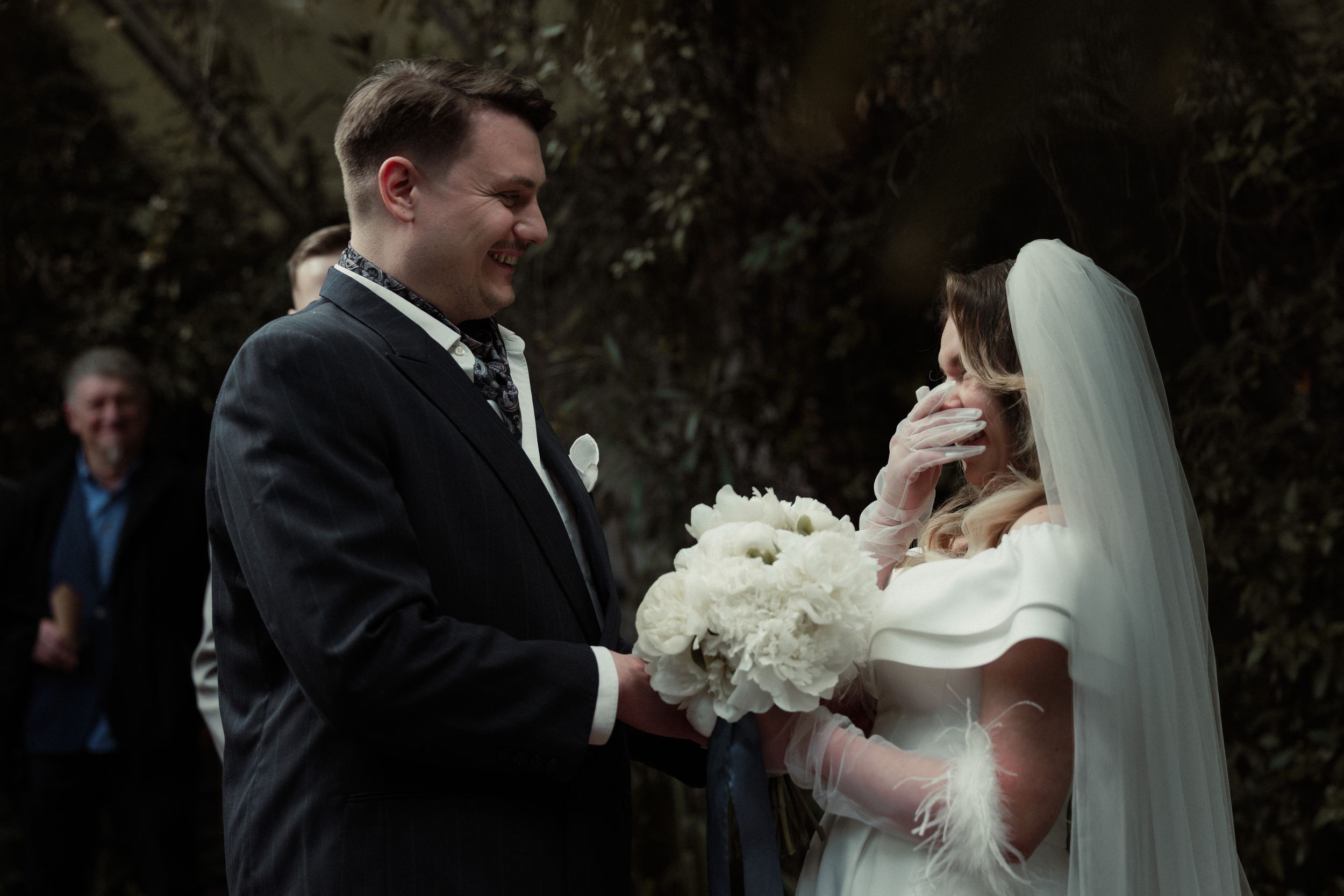 A bride and groom share their first dance at an outdoor wedding celebration.