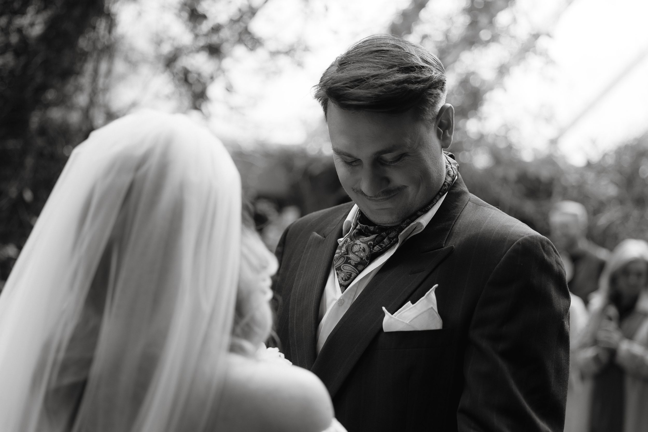 A series of black and white photographs showing tender moments from a wedding ceremony celebration.