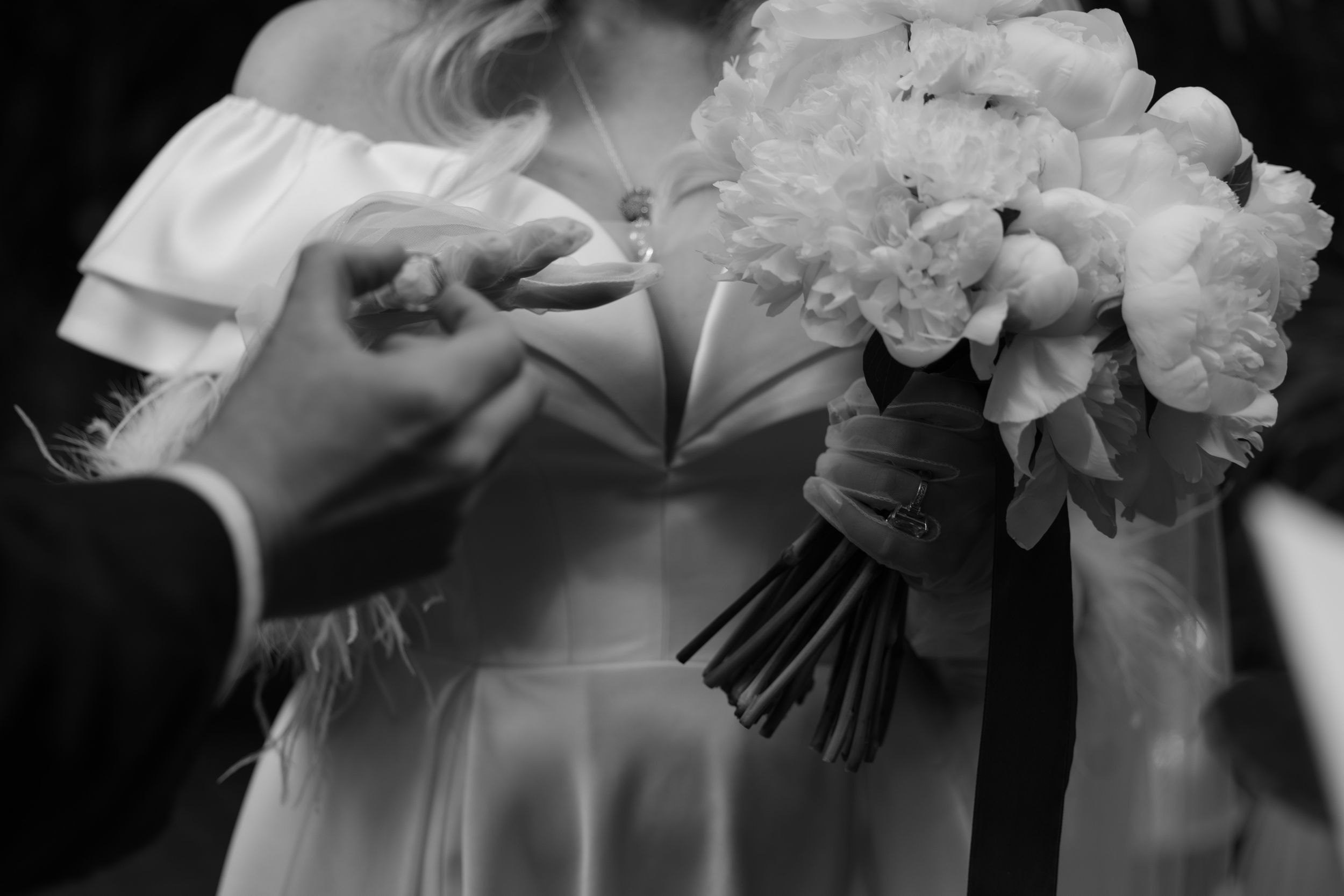 A black and white photo series showing elegant bridal bouquets being held in formal wedding attire.