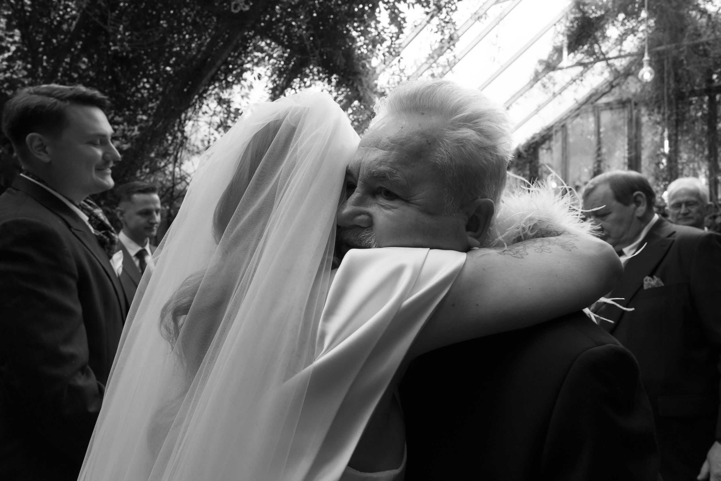 A sequence of black and white wedding photos showing blurred motion and intimate moments during a ceremony.