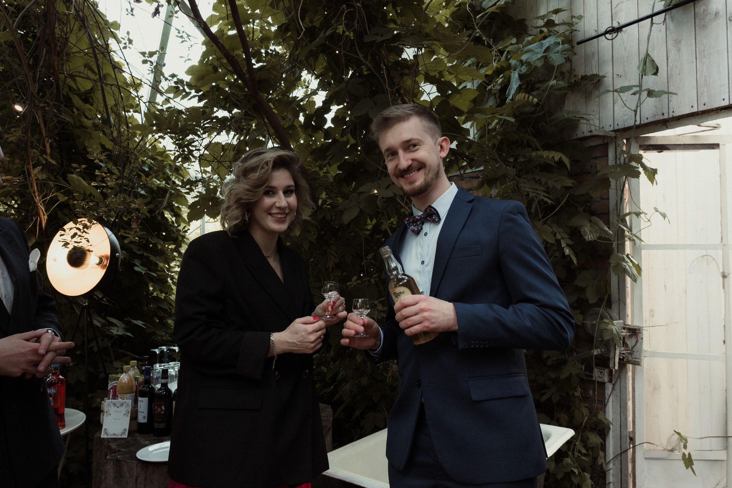 A series of candid black and white photos showing couples sharing champagne and celebrating together outdoors.