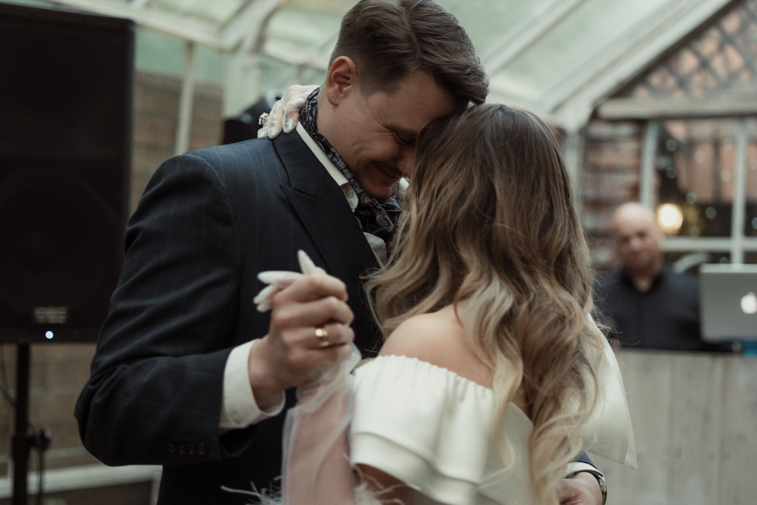 A couple shares an intimate moment on their wedding day with the groom dipping the bride for a romantic kiss.