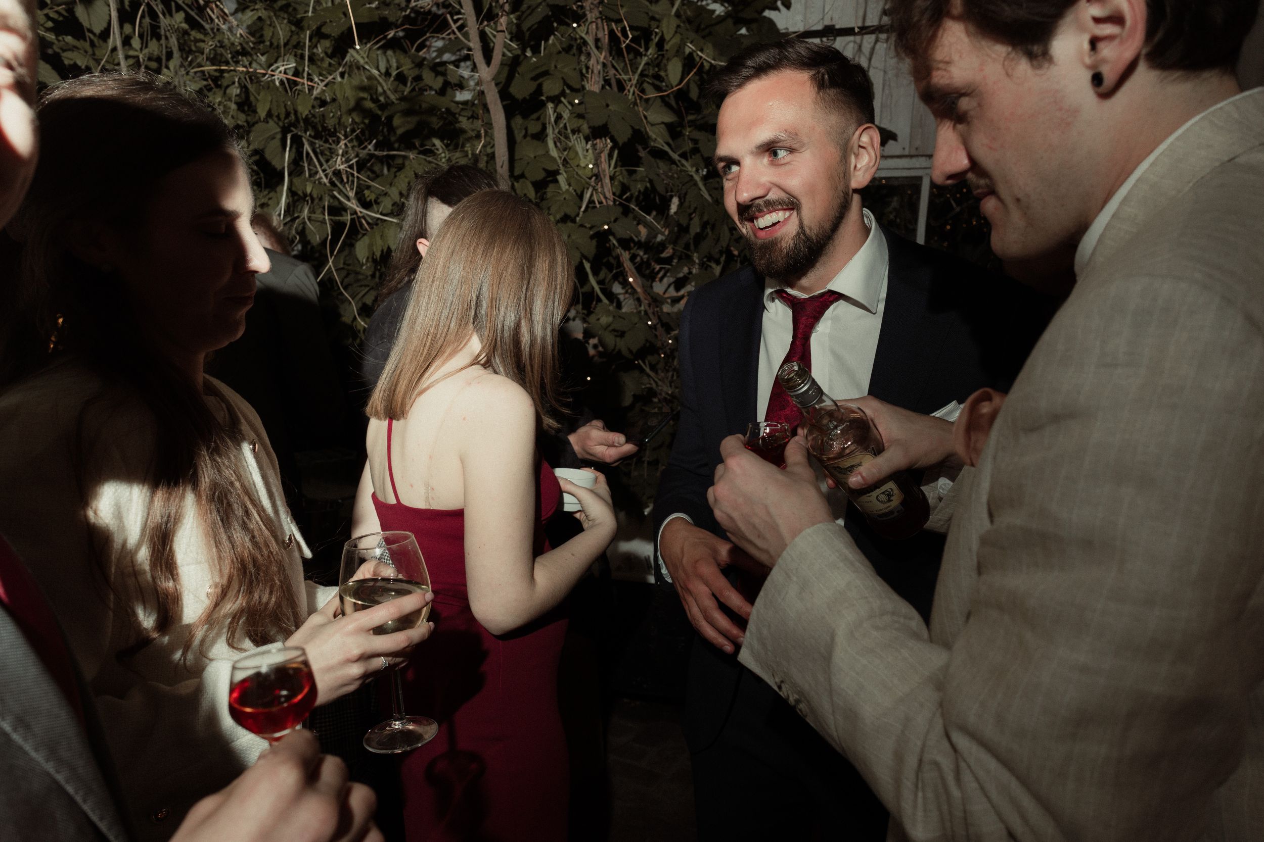 A lively wedding reception dance floor filled with guests celebrating in formal attire.