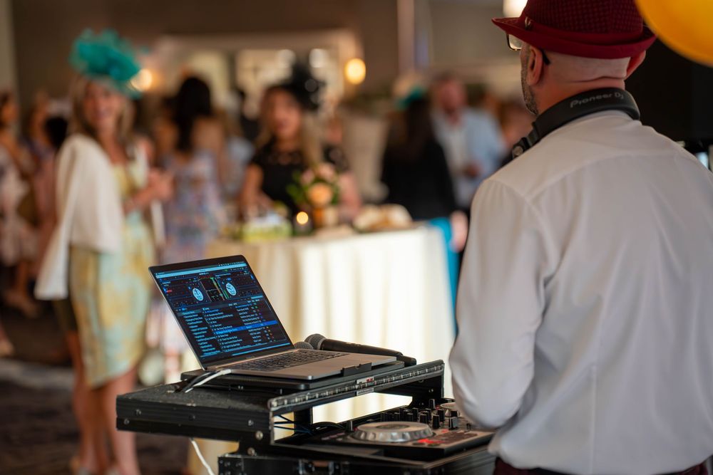 Professional DJ equipment and controllers set up at an event venue.
