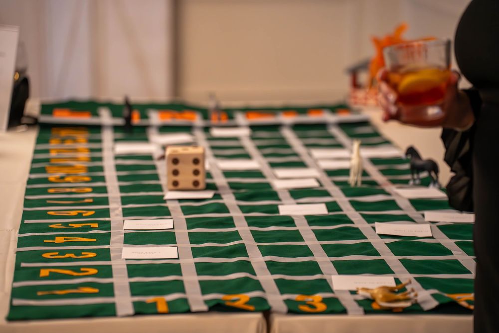 Long table with green rectangular sections laid out for an event activity.