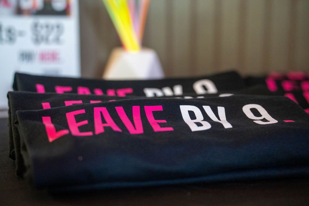 Black banner with pink text displayed at an event.