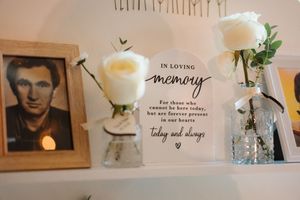 Series of decorative wall art and framed photographs with text quotes and plants in a modern home interior design setup.