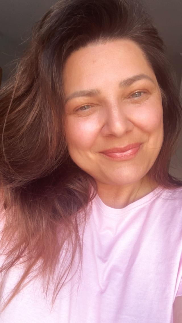Close-up self portrait series in pink shirt showing joyful expressions.