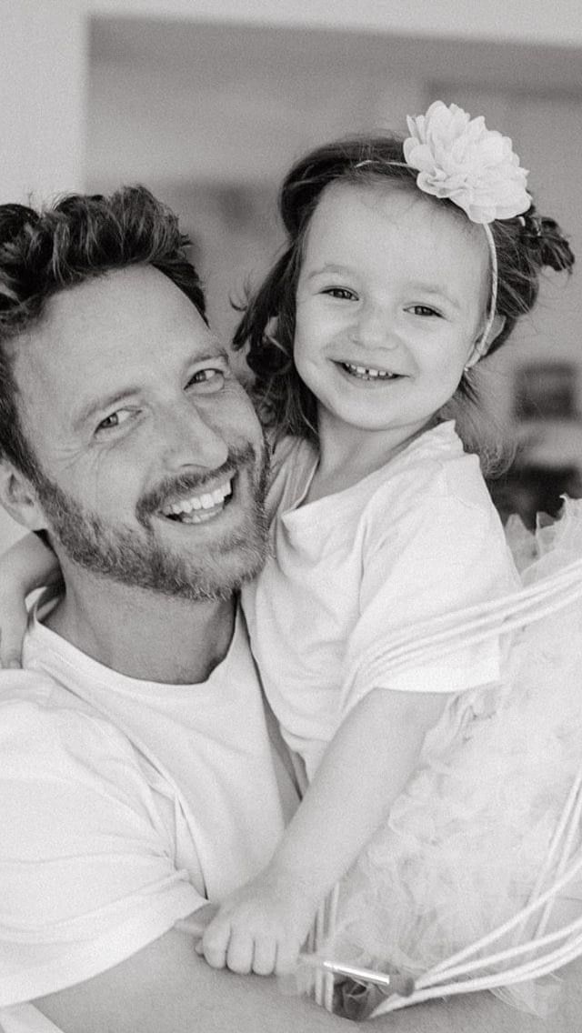 Sweet candid black and white moments showing affectionate family interaction.