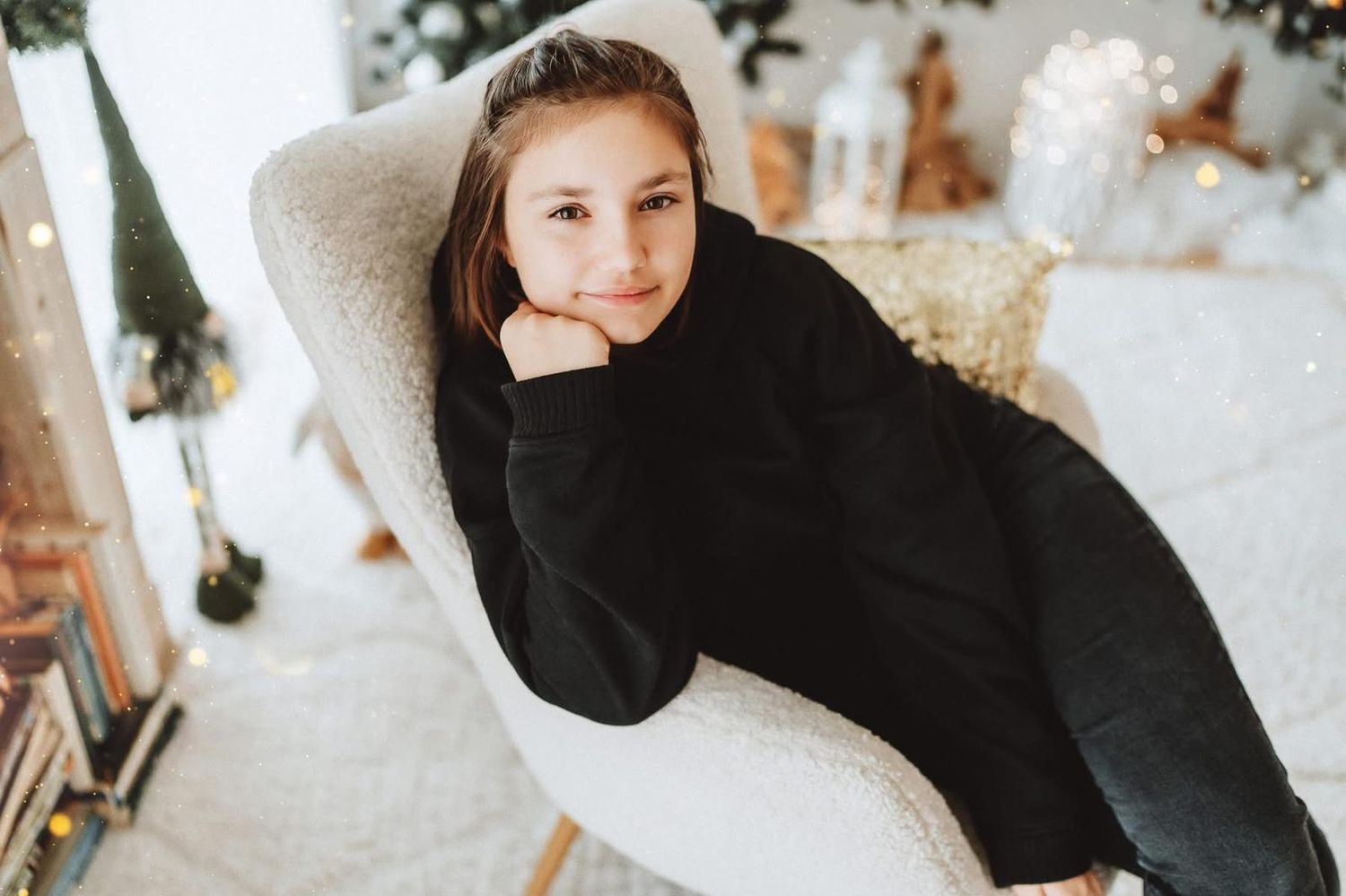 Winter scene with festive holiday decorations and black clothing against white backdrop.
