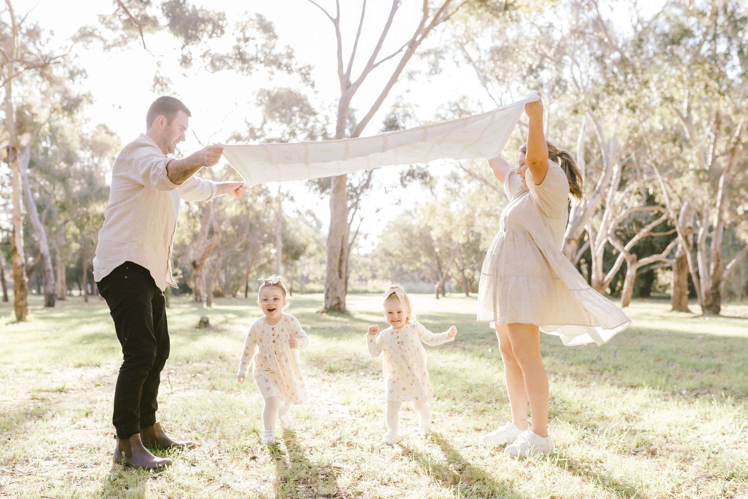 A sequence of candid photos showing people joyfully moving and dancing outdoors in a sunlit natural setting.