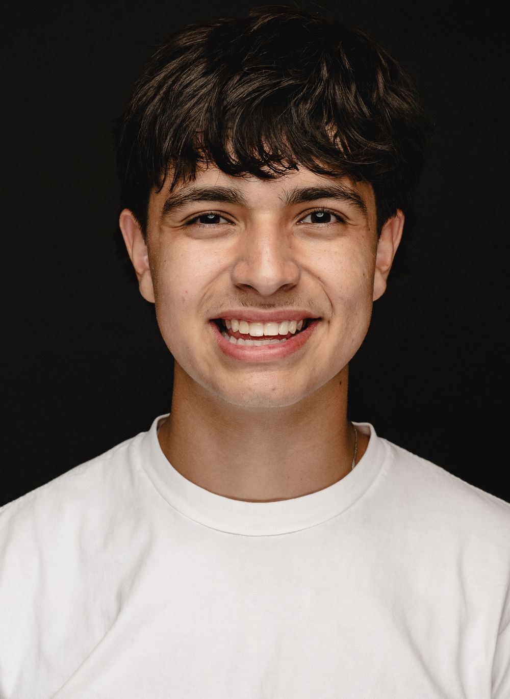 A series of headshots against a black background showing expressions transitioning from neutral to joyful.