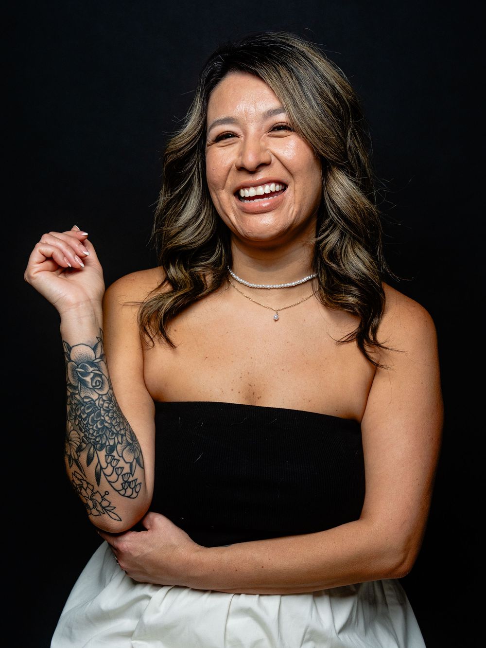 Professional portrait series showing joyful expressions against dark background with black and white outfit.