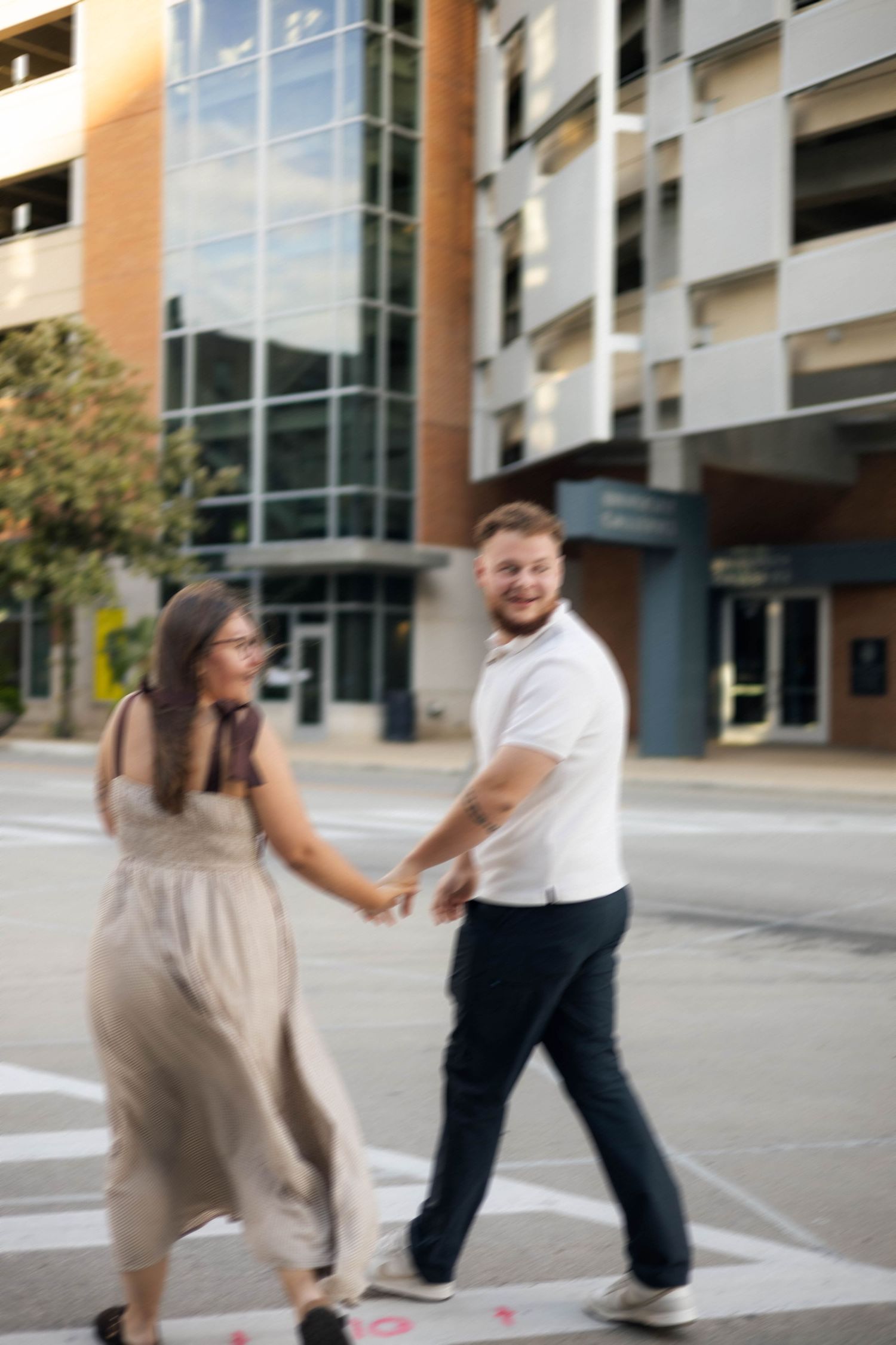 Outdoor uptown Normal summer engagement photos in Normal, Illinois