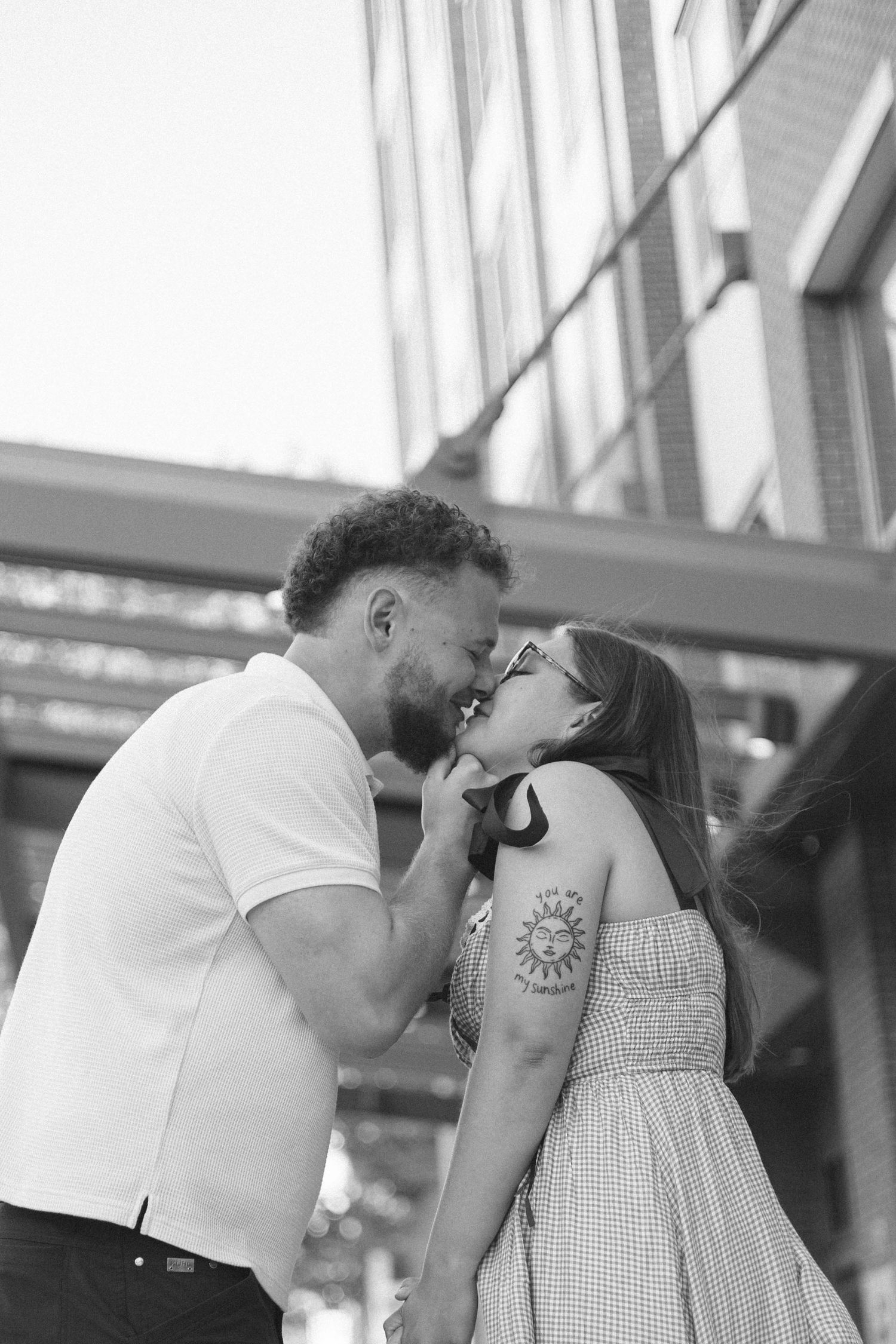 Outdoor uptown Normal summer engagement photos in Normal, Illinois