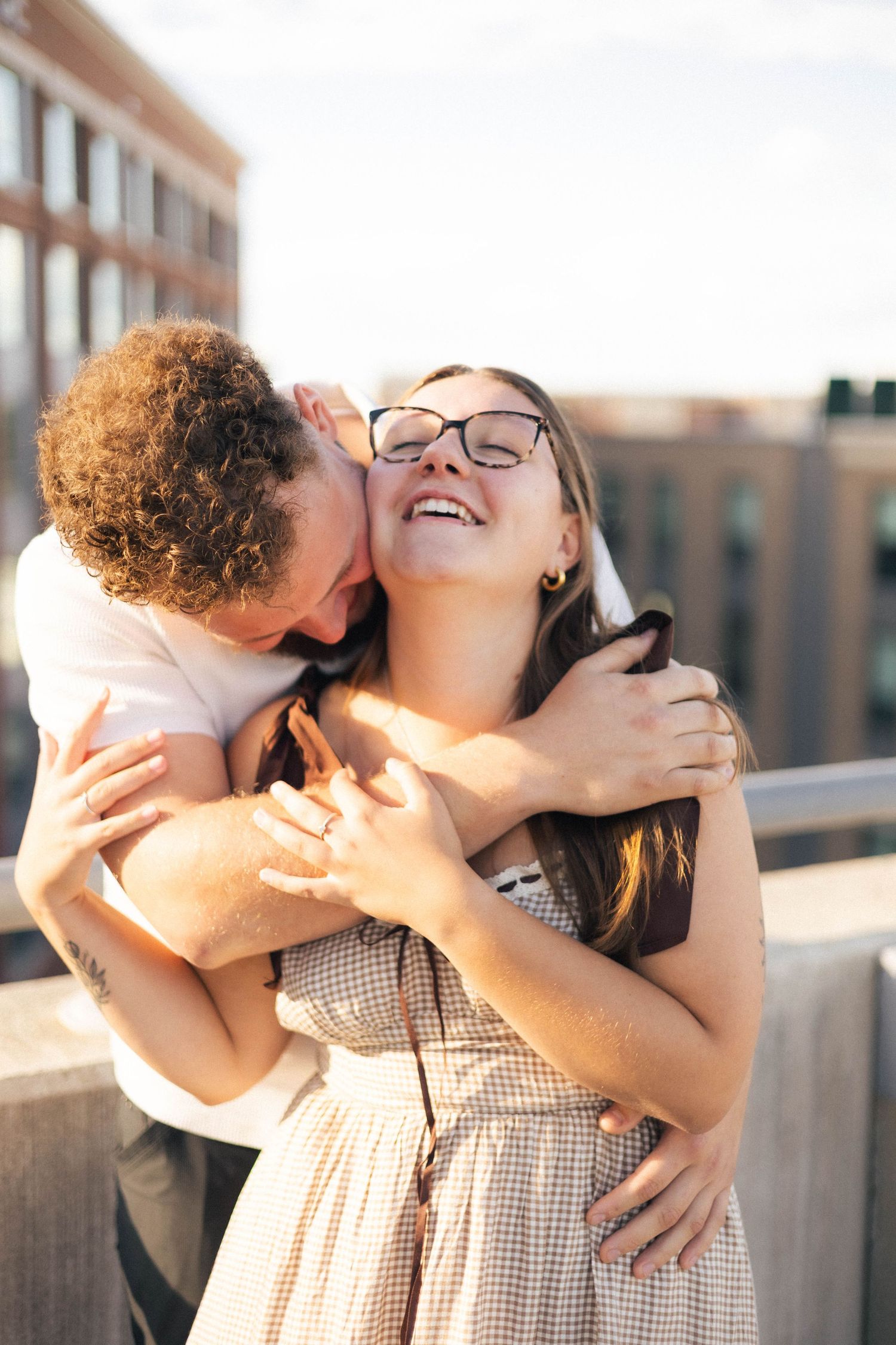 Outdoor uptown Normal summer engagement photos in Normal, Illinois