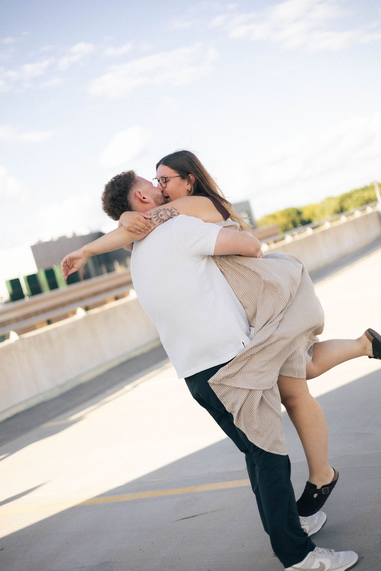 Outdoor uptown Normal summer engagement photos in Normal, Illinois